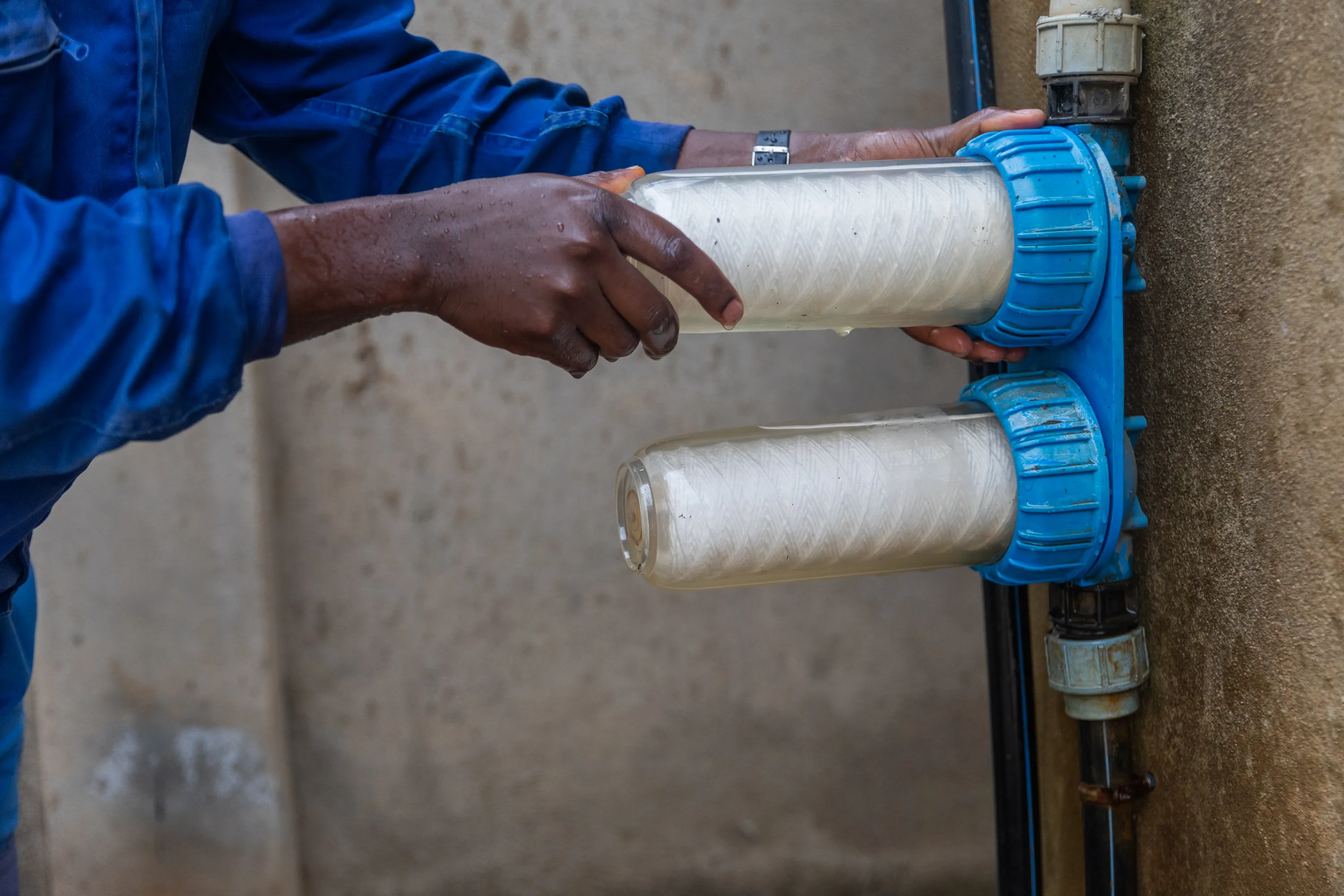 african plumber replaces the water filters