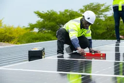 engineer and technician inspects solar panel installation